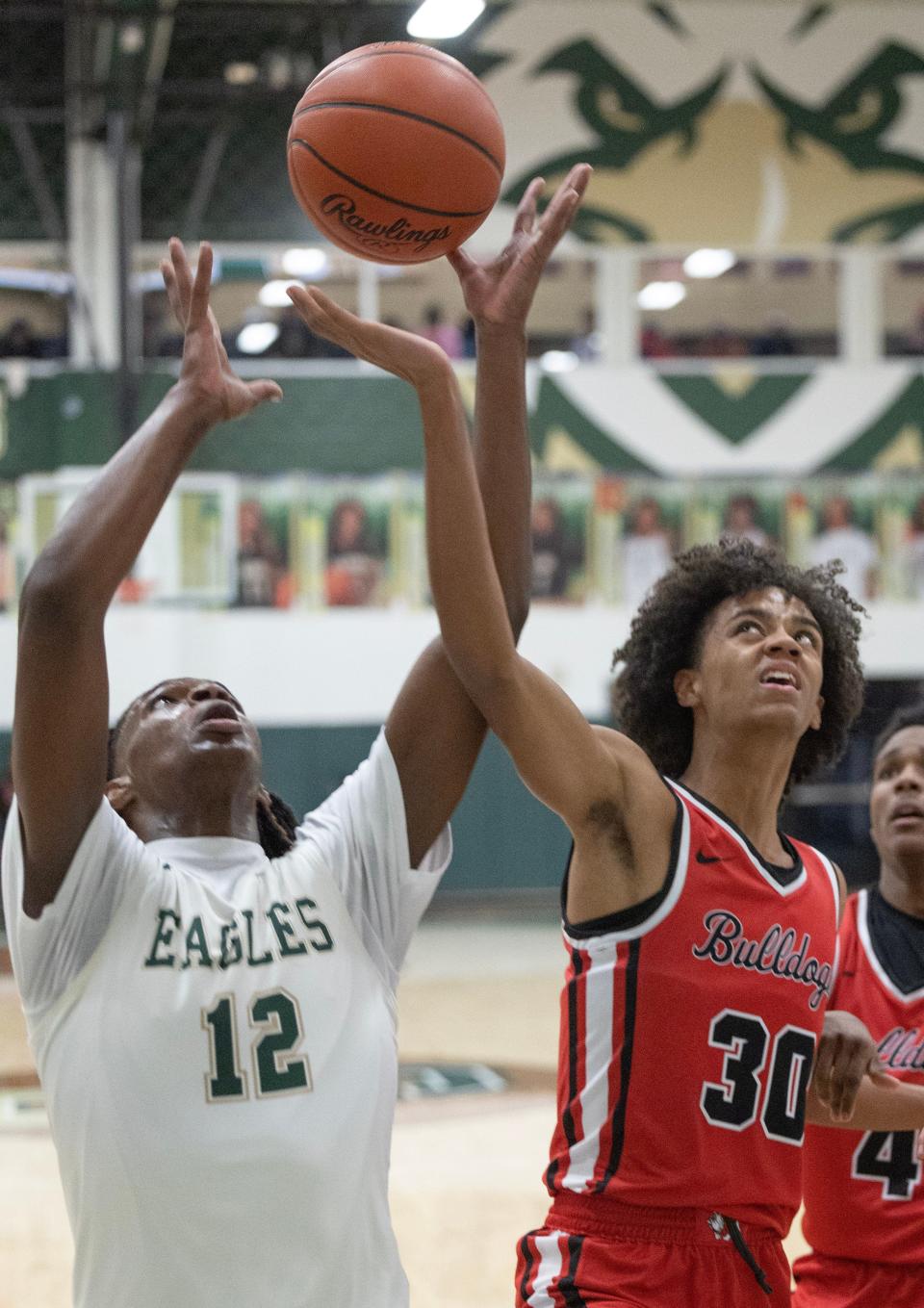 McKinley's Reed Sims Jr. (30) battles GlenOak's Dai'Jhon Robinson (12) for a rebound during a boys high school basketball game at GlenOak on Thursday, December 14, 2023.