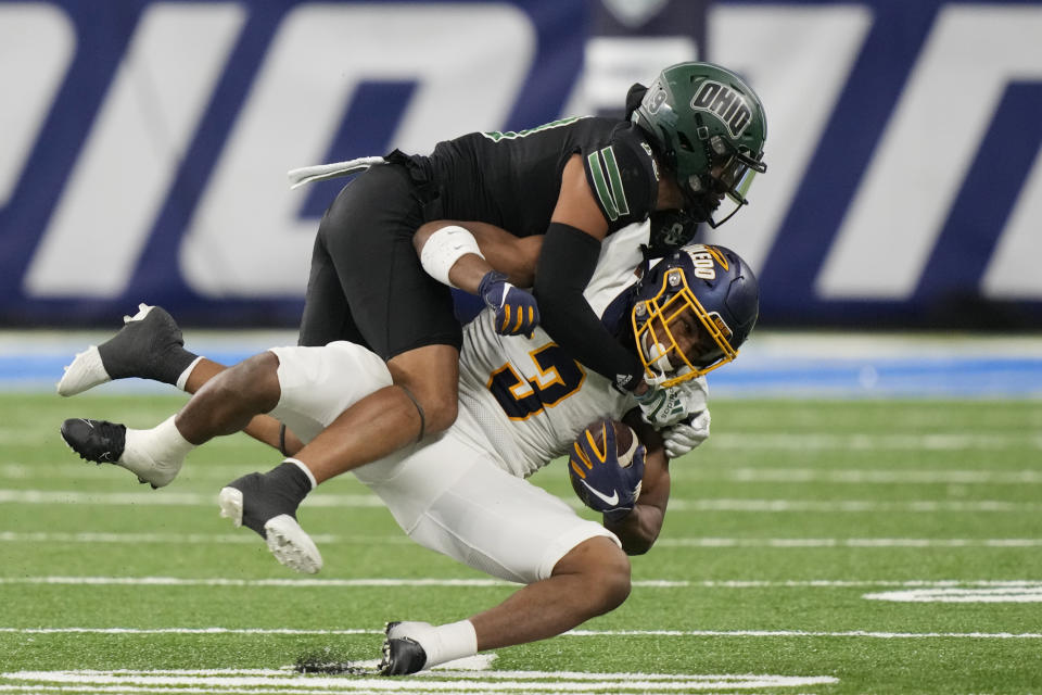 Toledo running back Micah Kelly (3) is tackled by Ohio cornerback Zack Sanders during the second half of the Mid-American Conference championship NCAA college football game, Saturday, Dec. 3, 2022, in Detroit. (AP Photo/Carlos Osorio)