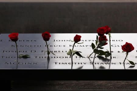 Roses are placed on names on the memorial during the ceremony marking the 15th anniversary of the attacks on the World Trade Center at The National September 11 Memorial and Museum in Lower Manhattan in New York City, U.S. September 11, 2016. REUTERS/Brendan McDermid