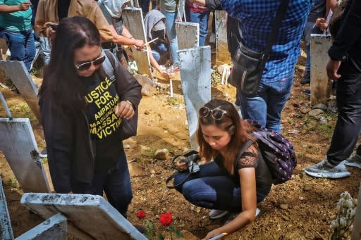 On the 10th anniversary, relatives visit the site of the massacre where markers represent the 58 victims of the November 23, 2009 killings