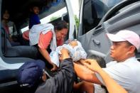 REFILE-REMOVING RESTRICTIONS Residents evacuate their homes are seen onboard a vehicle after Islamist militants, who had holed up in a primary school, retreated after a gunbattle with troops but were holding some civilians hostage, in Pigcawayan, North Cotabato, Philippines June 21, 2017. REUTERS/Marconi Navales