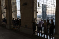 People visit the view terrace of the Palace of Culture and Science in Warsaw, Poland, Saturday, Aug. 27, 2022. The Palace of Culture, a Stalin-era skyscraper in the center of Warsaw remains a prominent reminder of the communist era and Soviet domination. The building was a gift from dictator Josef Stalin and was long seen as a symbol of communism. When communism fell more than 30 years ago, some called for it to be torn down. But it is a part of a city's life and has since received protection status as a place of historical significance. (AP Photo/Michal Dyjuk)