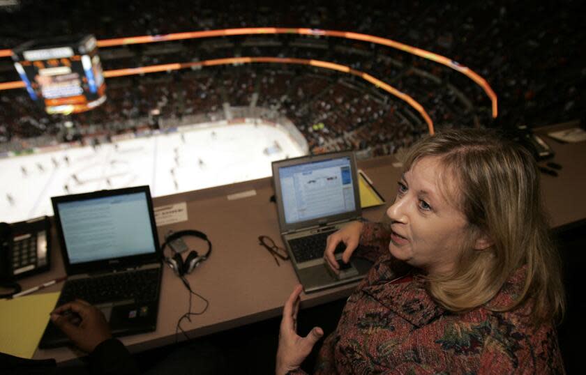 Los Angeles Times hockey writer and columnist, Helene Elliott, in the press box high.
