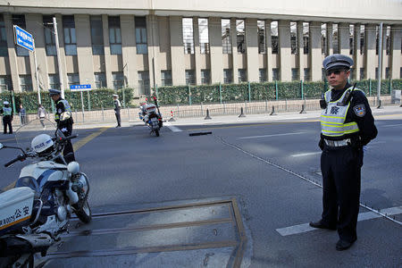 Policemen stand guard on a blocked road near the Museum of the First National Congress of the Chinese Communist Party, as China's President Xi Jinping visits the museum, in Shanghai, China, October 31, 2017. REUTERS/Aly Song