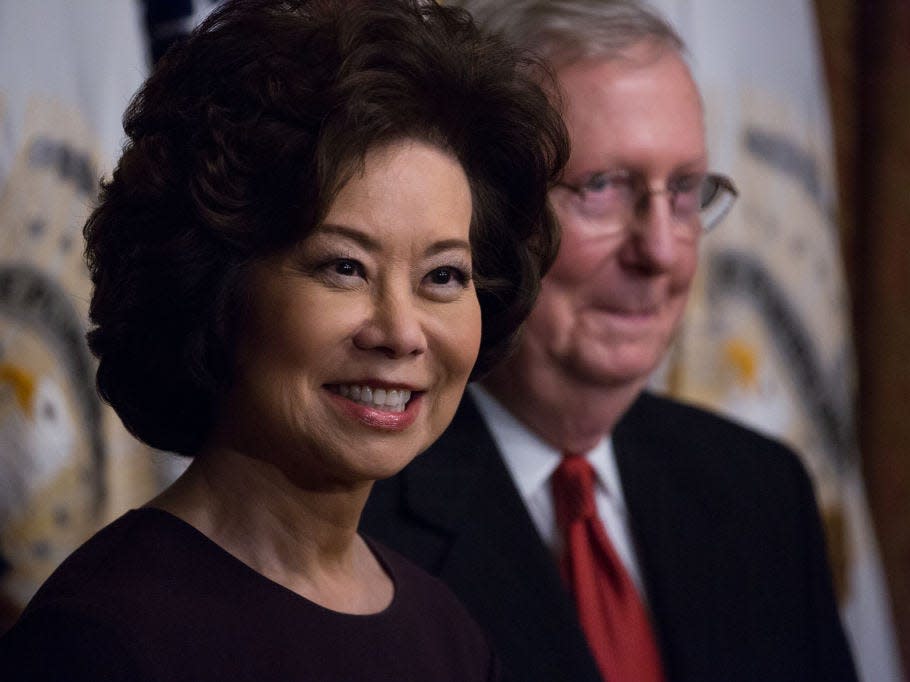 Elaine Chao, with Mitch McConnell visible in the background