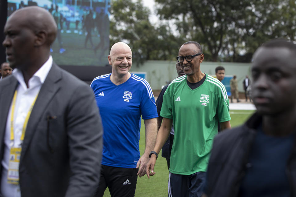 FIFA president Gianni Infantino, centre left, walks with Rwanda's President Paul Kagame, centre right, at a football tournament for delegates to the 73rd FIFA Congress, in Kigali, Rwanda, Wednesday, March 15, 2023. The congress is due to take place in the Rwandan capital on Thursday. (AP Photo)