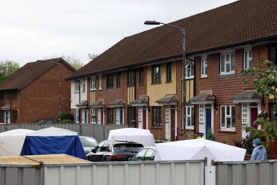 Police and forensic officers, along with police tents, at the scene in Bermondsey (Getty)