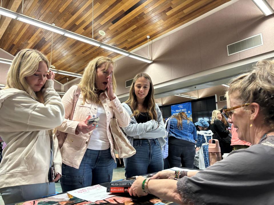 Melissa Gilbert signs an autograph for Deborah Mendes (center), who came with her daughters, Skylar (left) and Karyss (right).