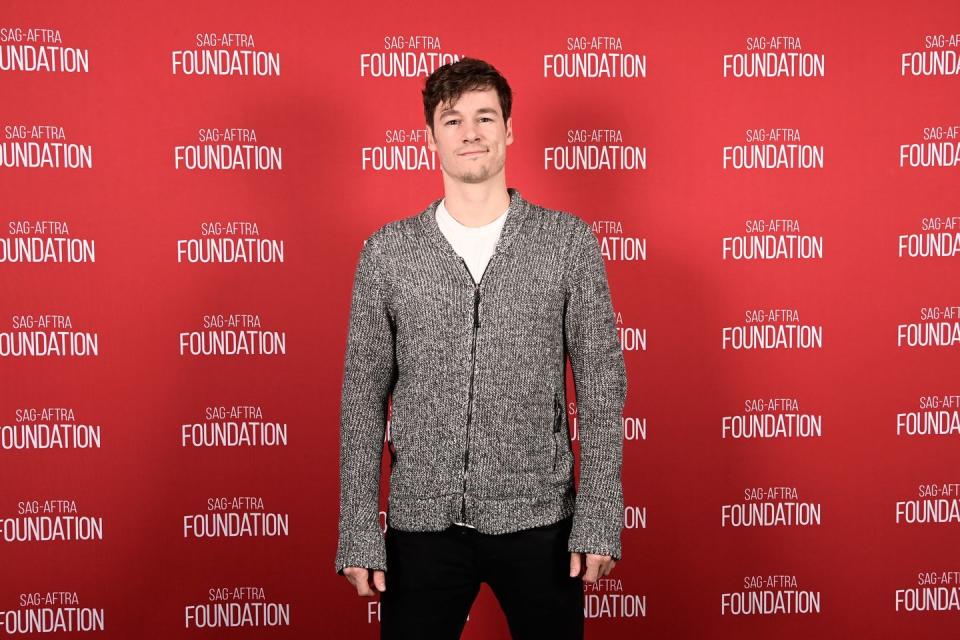 Actor Kyle Allen at the Sag Aftra Foundation Conversations presented on the red carpet in a gray hoodie