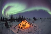 Hudson Bay, Canada. <br><br>A tent sits beneath the Northern Lights. <br><br>Camera: Canon 5D MkII <br><br>Thomas Kokta, Germany <br><br>Runner-up, One Shot Wild Moments (single image category)