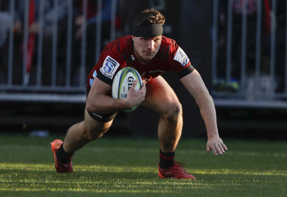 Crusaders George Bridge scores hits first try during the Super Rugby Aotearoa rugby game between the Crusaders and the Highlanders in Christchurch, New Zealand, Sunday, Aug. 9, 2020. (AP Photo/Mark Baker)