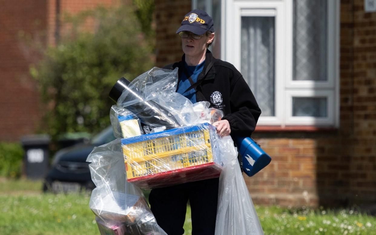 A police officer carries out bagged items from a property in Havant where Louise Smith was staying before she vanished on May 8   - Jordan Pettitt/Solent  