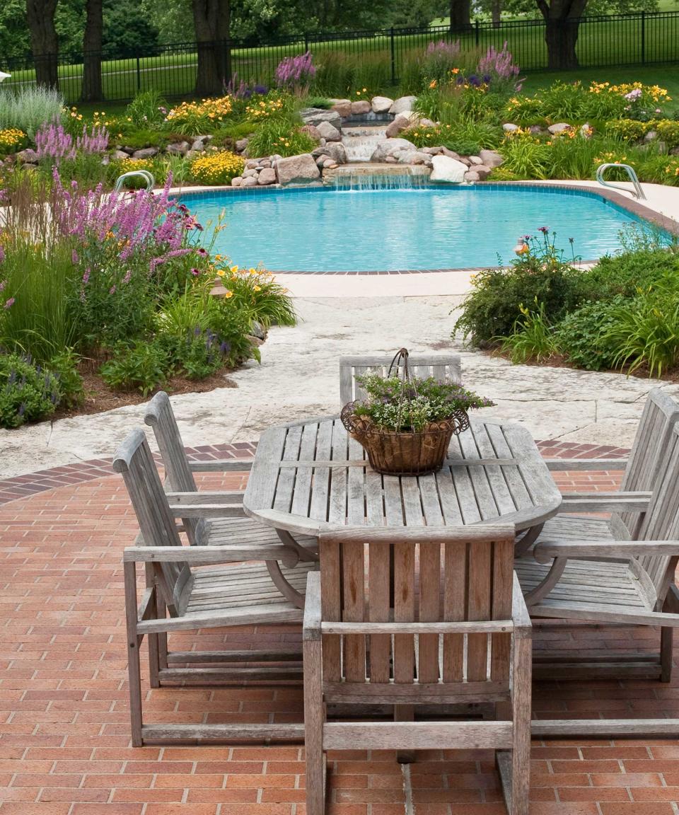 backyard with brick paving and pool