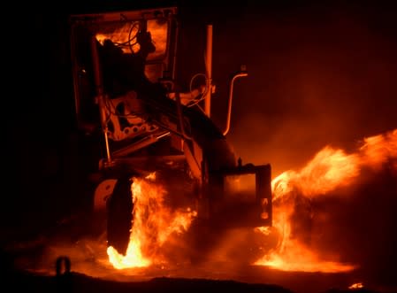 Firefighters battle a wind-driven wildfire in Sylmar, California