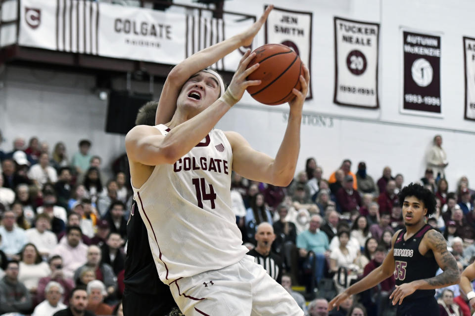 Colgate forward Keegan Records (14) is fouled by Lafayette center Justin Vander Baan as he drives to the basket during the first half of an NCAA college basketball game for the Patriot League tournament championship in Hamilton, N.Y., Wednesday, March 8, 2023. (AP Photo/Adrian Kraus)