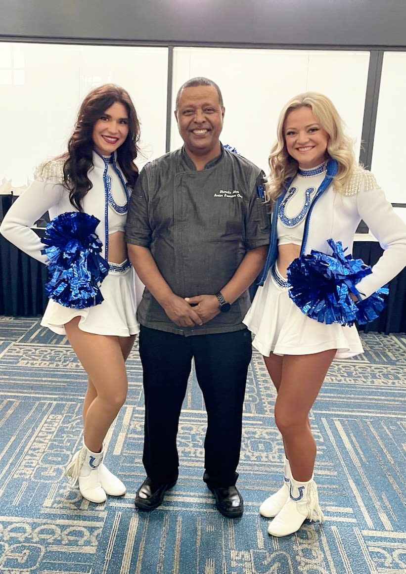 Chef Adem with two Indianapolis Colts cheerleaders. (Photo: Shumu Adem)