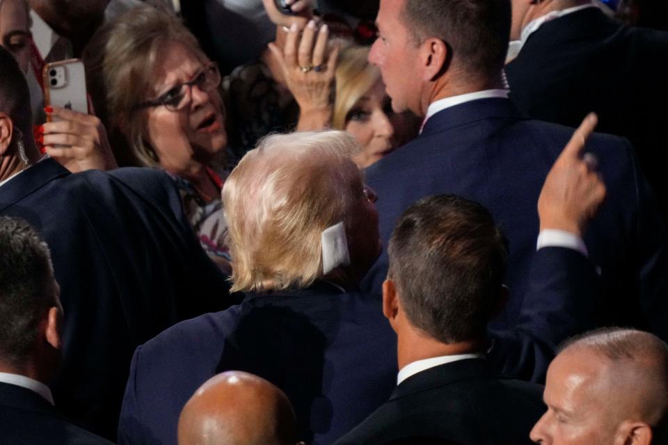 Republican presidential nominee Donald J. Trump's bandaged right ear is seen as he leaves the convention floor at the end of the first day of the Republican National Convention. The RNC kicked off the first day of the convention with the roll call vote of the states.