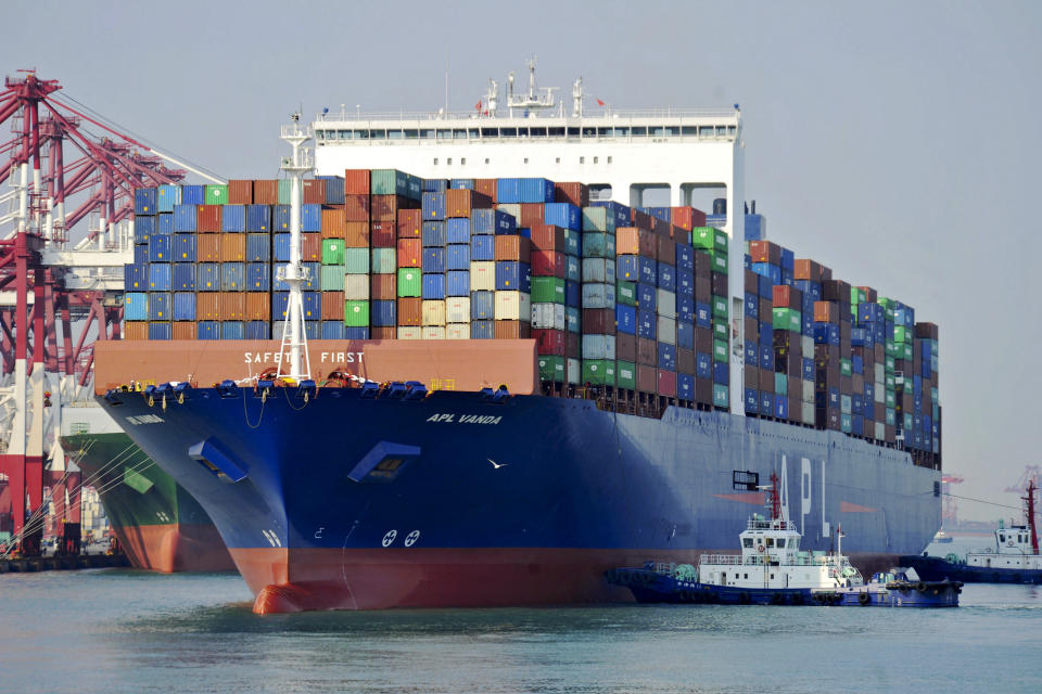 In this Monday, April 1, 2019, photo, tugboats push a container vessel to the dockyard in a port in Qingdao in east China's Shandong province. Trade tensions between China and the United States are putting a drag on economies in the region, with growth likely to continue to slow in the coming two years, the Asian Development Bank says in a report released Wednesday, April 3, 2019. (AP Photo)