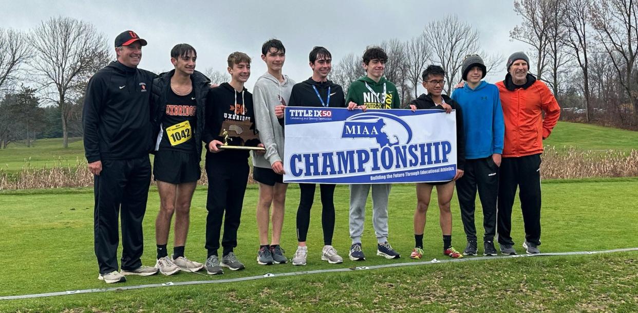 Coaches and athletes from the Uxbridge boys' cross-country team celebrate the win in the Division 3B race on Sunday at Gardner Municipal Golf Course.