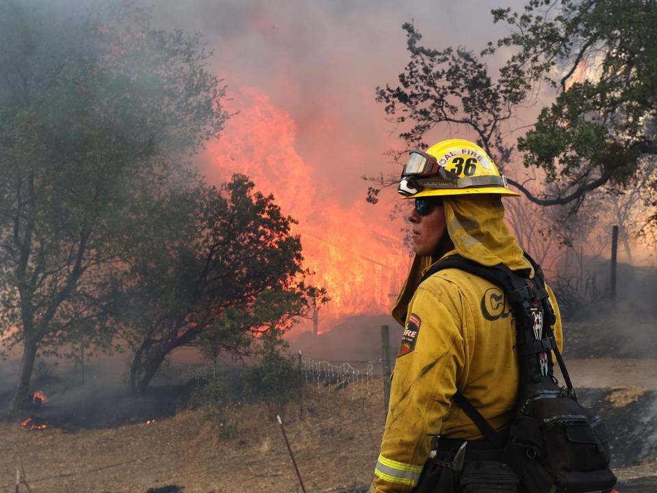 A Cal Fire firefighter monitors the Oak Fire on July 23, 2022 near Mariposa, California.