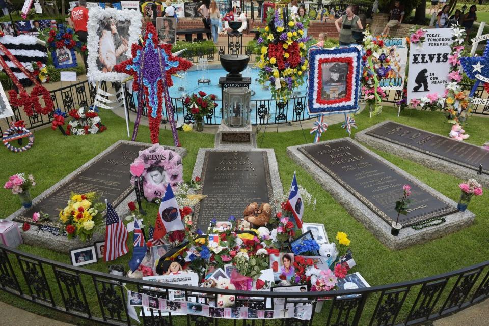 The maker is pictured in the Meditation Garden where Elvis Presley is buried alongside his grandmother and parents at his Graceland mansion on August 12, 2017 in Memphis, Tennessee. Elvis Presley, American icon and King of rock n roll, transformed popular culture, sold over a billion records and is idolized as ever on the 40th anniversary of his tragic death. His Graceland mansion in Memphis, Tennessee -- the second most famous home in the United States after the White House -- expects more than 50,000 people to descend for the biggest ever annual celebration of his life 40 years after his death aged 42 on August 16, 1977. / AFP PHOTO / MANDEL NGAN / With AFP Story by Jennie MATTHEW: Elvis: 40 years since the death of an American icon (Photo credit should read MANDEL NGAN/AFP via Getty Images)