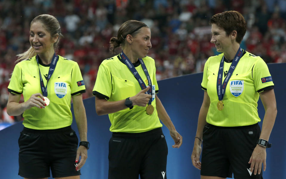 Assistant referee Michelle O'Neill of Ireland, right, referee Stephanie Frappart of France, center, and assistant referee Manuela Nicolosi of France after getting their medals after the UEFA Super Cup soccer match between Liverpool and Chelsea, in Besiktas Park, in Istanbul, Wednesday, Aug. 14, 2019.(AP Photo/Lefteris Pitarakis)