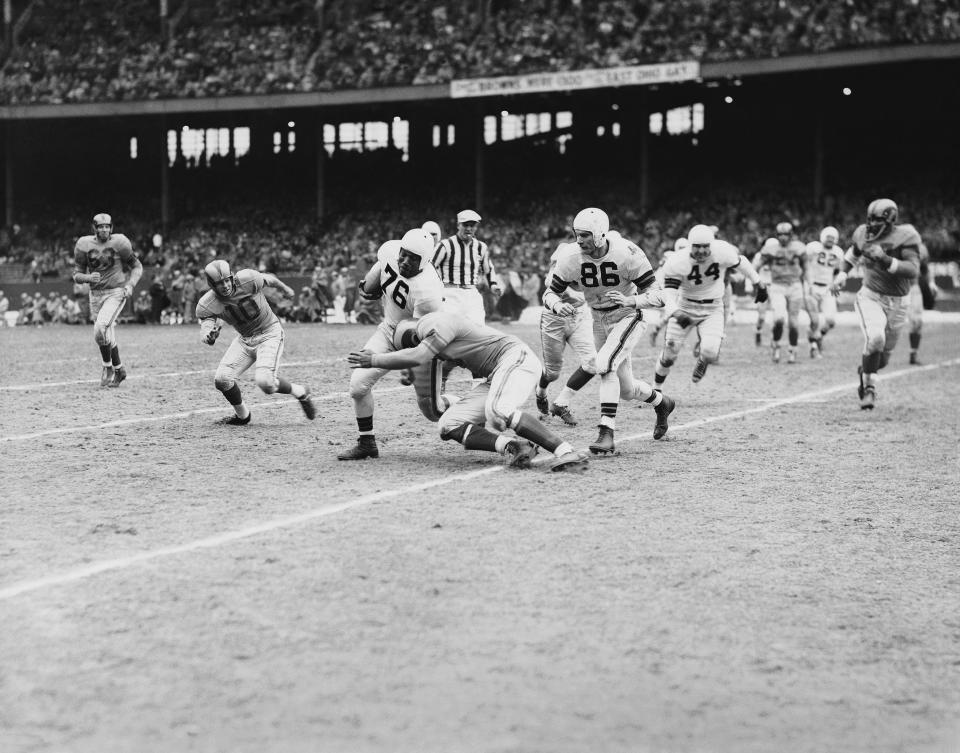 Cleveland fullback Marion Motley (76) picked up 12 yards and a first down in the fourth quarter before he was tackled by Paul Younger of Los Angeles in the NFL title game at Cleveland on Dec. 24, 1950. The Browns won 30-28.