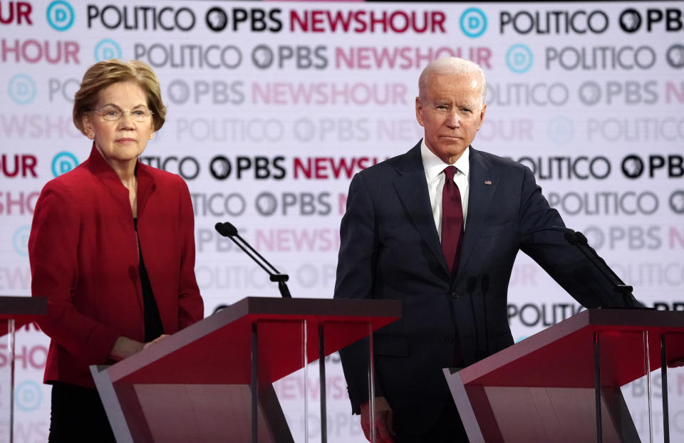 Democratic U.S. presidential candidates Senator Elizabeth Warren and former Vice President Joe Biden listen to a question during the sixth Democratic presidential candidates campaign debate at Loyola Marymount University in Los Angeles, California, U.S., December 19, 2019. REUTERS/Mike Blake