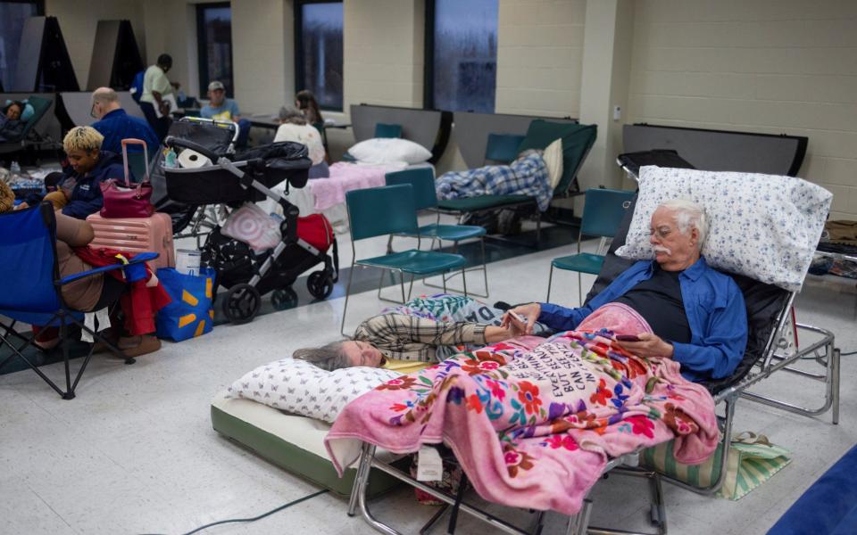 Donald Draughon and his wife Vicki wait for the arrival of Hurricane Helene at Lincoln High School, which was opened as a shelter in Tallahassee, Florida on Friday