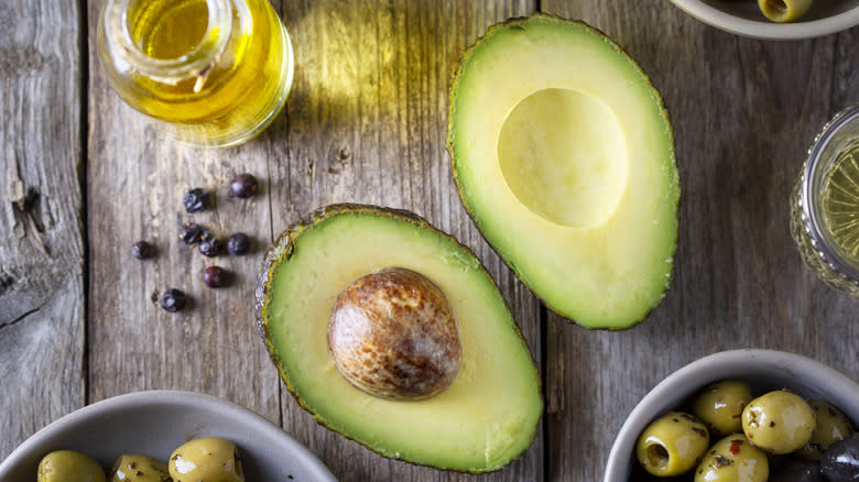 Halved avocado with oil