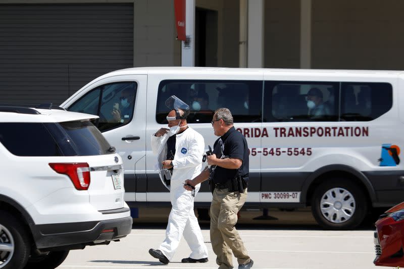 A rescue worker wearing protective gear walks outside the passengers terminal where the Coral Princess ship, of Princess Cruises fleet, with patients affected by coronavirus disease (COVID-19)