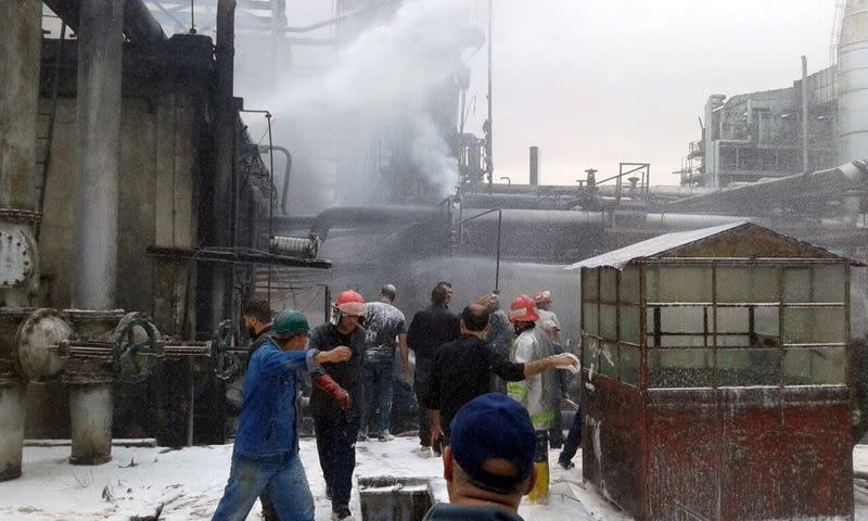 Firefighters try to put out a fire in main Homs refinery