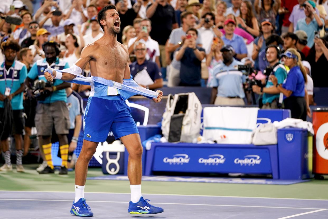 Novak Djokovic, of Serbia, rips his shirt in celebration after defeating Carlos Alcaraz, of Spain, at the conclusion of the men’s singles final of the Western & Southern Open tennis tournament, Sunday, Aug. 20, 2023, at the Lindner Family Tennis Center in Mason, Ohio. Djokovic won, 5-7, 7-6, 7-6.