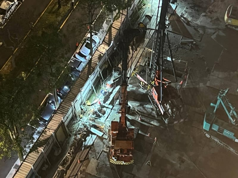 台北市松山區慶城街一處新建工地晚間9時發生地層下陷，導致緊鄰工地圍籬的4輛汽車傾斜。（翻攝畫面／中央社）