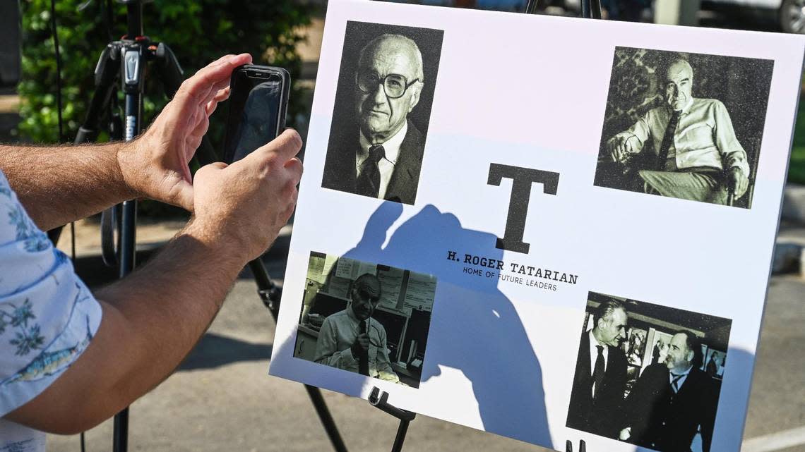 Media members take photos of late Fresno journalist and Fresno State professor H. Roger Tatarian displayed during a renaming ceremony at H. Roger Tatarian Elementary School in north Fresno on Wednesday, Sept. 7, 2022.