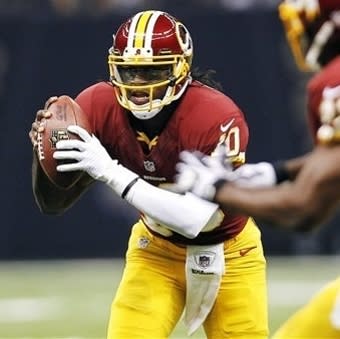 Robert Griffin III scrambles in the first half against the New Orleans Saints. (AP Photo/Gerald Herbert)