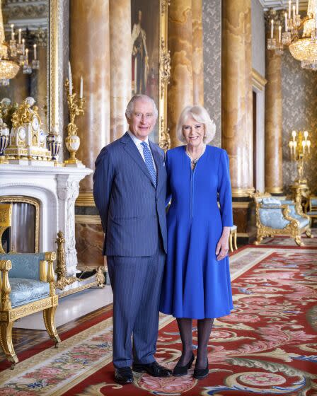 Britain's King Charles III and Camilla, Queen Consort pose in the Blue Drawing Room at Buckingham Palace.