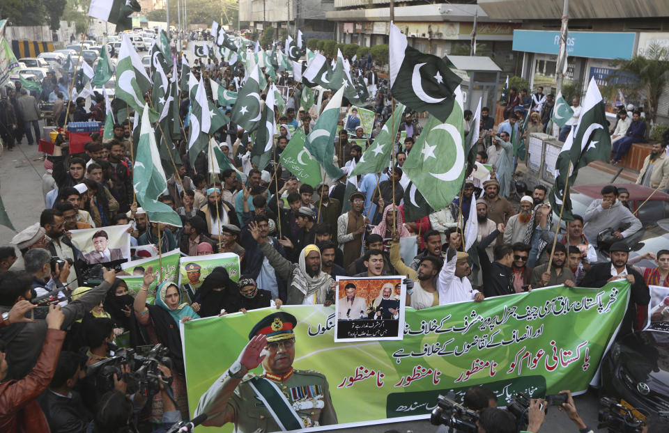 Supporters of former Pakistani military ruler Gen. Pervez Musharraf protest a court's decision, in Karachi, Pakistan, Wednesday, Dec. 18, 2019. The Pakistani court sentenced Musharraf to death in a treason case related to the state of emergency he imposed in 2007 while in power, officials said. Musharraf who is apparently sick and receiving treatment in Dubai where he lives was not present in the courtroom. (AP Photo/Fareed Khan)