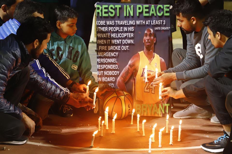 Gurgaon Basketball players light candles as they pay tribute to American professional basketball player Kobe Bryant in Gurgaon on January 27, 2020. (Photo by MANOJ KUMAR/AFP via Getty Images)