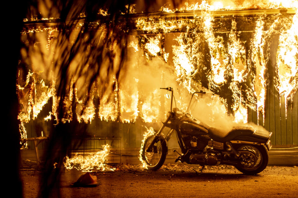 Flames engulf a customised motorcycle and house in southern California. Image: Yahoo News