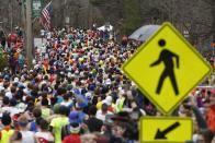 Runners in the first wave make their way down the course of the Boston Marathon in Hopkinton, Massachusetts, April 20, 2015. A field of 30,000 runners is set to line up for the 119th running of the world's oldest annual marathon. REUTERS/Dominick Reuter