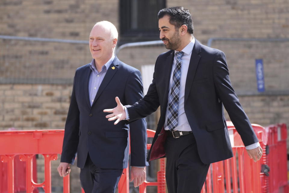 MSP Joe FitzPatrick, left, walks with Scotland's First Minister Humza Yousaf during a visit to the Hillcrest Homes housing development in Dundee, Scotland, Friday April 26, 2024. (Andrew Milligan/PA via AP)
