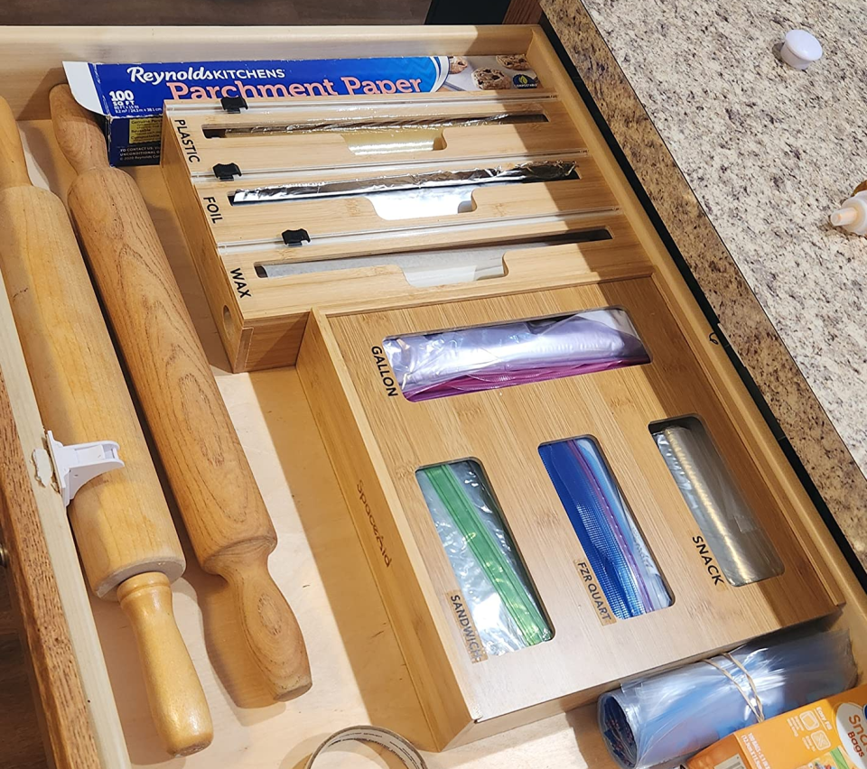 a reviewer shows both wooden organizers in their drawer
