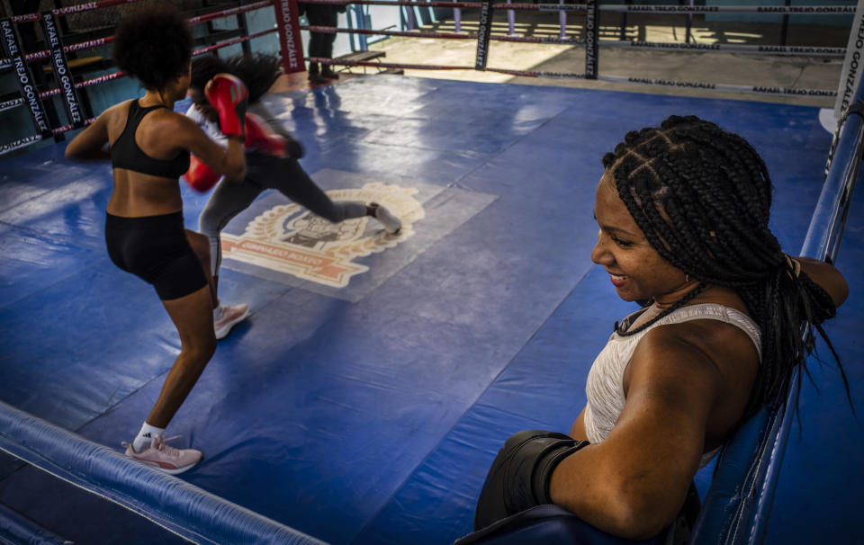 Ydamelys Moreno, right, watches as fellow female boxers train in Havana, Cuba, Monday, Dec. 5, 2022. Cuban officials announced on Monday that women boxers would be able to compete for the first time ever. (AP Photo/Ramon Espinosa)