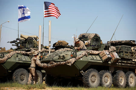 U.S. Marine sits on top of an armoured personnel carrier (APC) during Juniper Cobra, a U.S.-Israeli joint air defence exercise, in Zeelim, southern Israel, March 12, 2018. Picture taken March 12, 2018. REUTERS/Amir Cohen