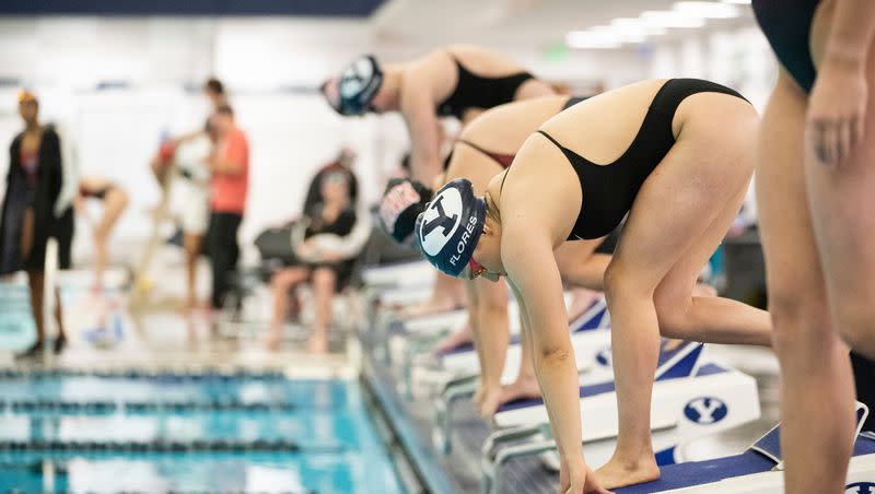 BYU swimmers prepare for the start of a race during meet against UNLV in 2022-23 season.