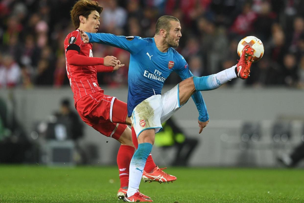 Impressive | Jack Wilshere in action against Cologne’s Yuya Osako, as Arsenal lost 1-0 but topped their Europa League group with a game to spare: David Price/Arsenal FC via Getty Images