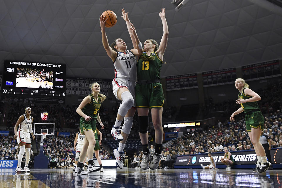 UConn's Lou Lopez Senechal (11) shoots as Vermont's Paula Gonzalez (13) defends in the first half of a first-round college basketball game in the NCAA Tournament, Saturday, March 18, 2023, in Storrs, Conn. (AP Photo/Jessica Hill)