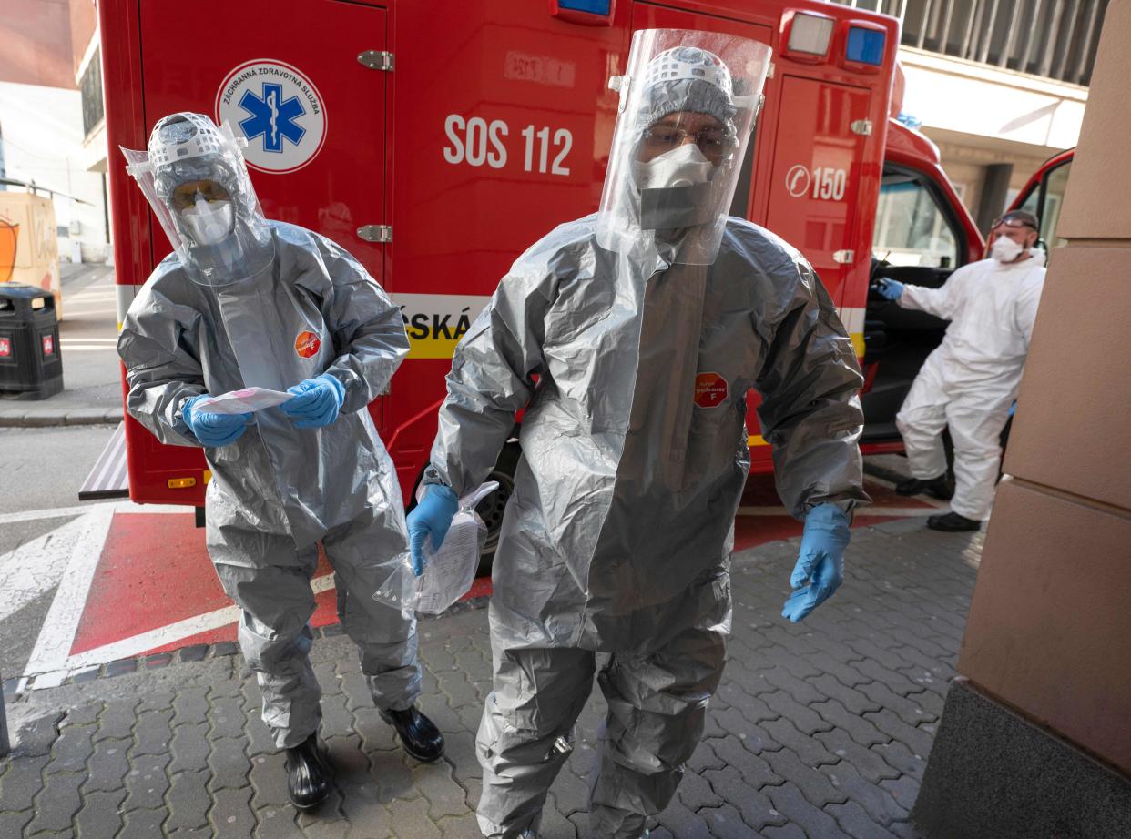 Slovak emergency personnel wearing protective suits enter the University hospital of Merciful Brothers where they are to a samples from 3 patients to be tested for the coronavirus COVID-19 in Bratislava, Slovakia on March 16, 2020. (Photo by JOE KLAMAR / AFP) (Photo by JOE KLAMAR/AFP via Getty Images)