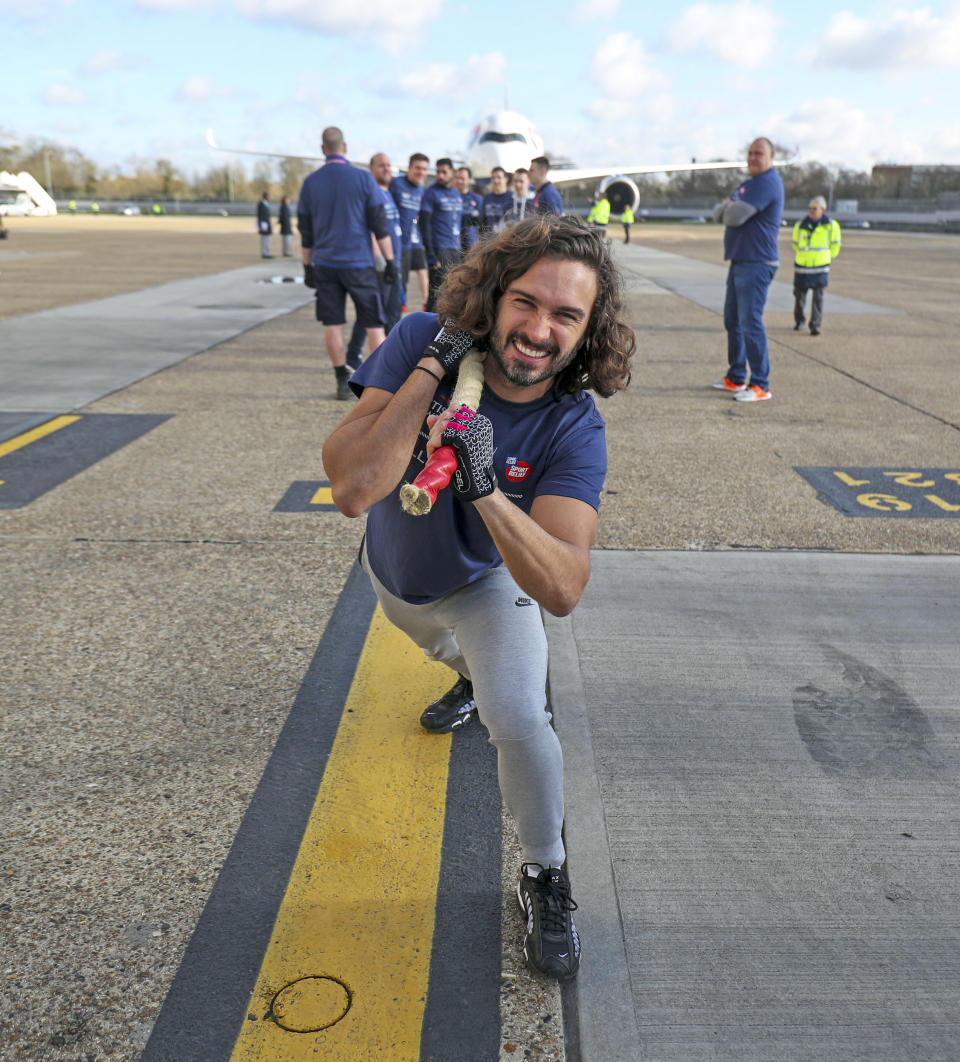 Joe Wicks poses for a photo before joining members of staff in an attempt to break the Guinness World Record for the heaviest 100m A350 plane pull during a Sport Relief event at Heathrow Airport in London.